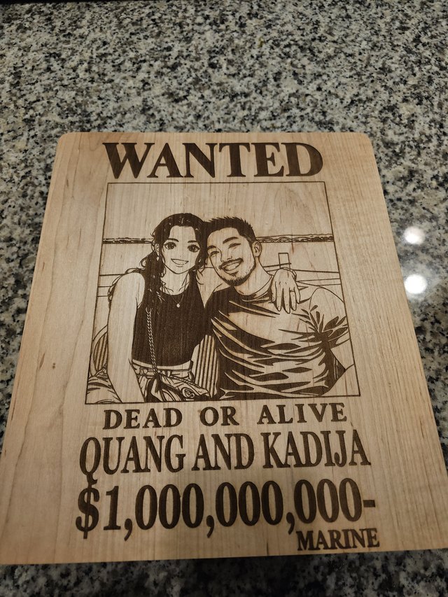 Light wood wall piece laser-engraved as a WANTED poster with an illustrated portrait