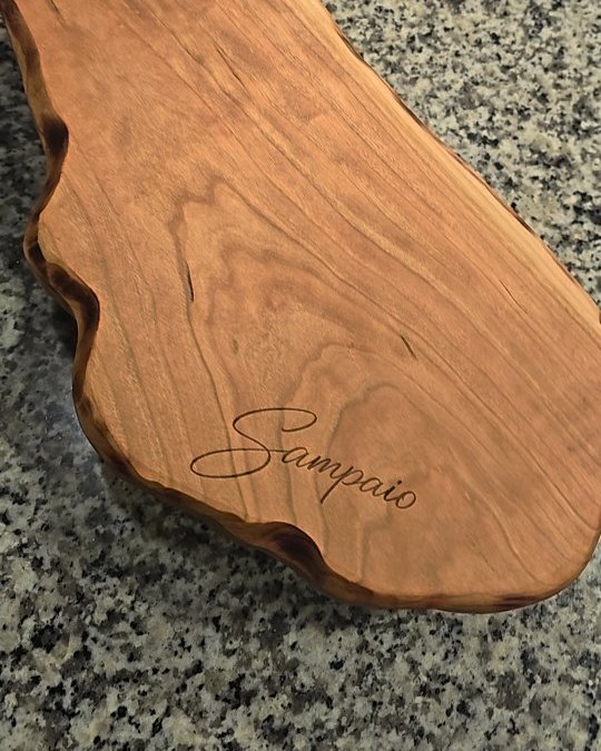 Live-edge wooden board with engraved script name